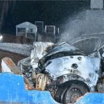 Motorista é retirado de carro em chamas após bater em muro de cemitério